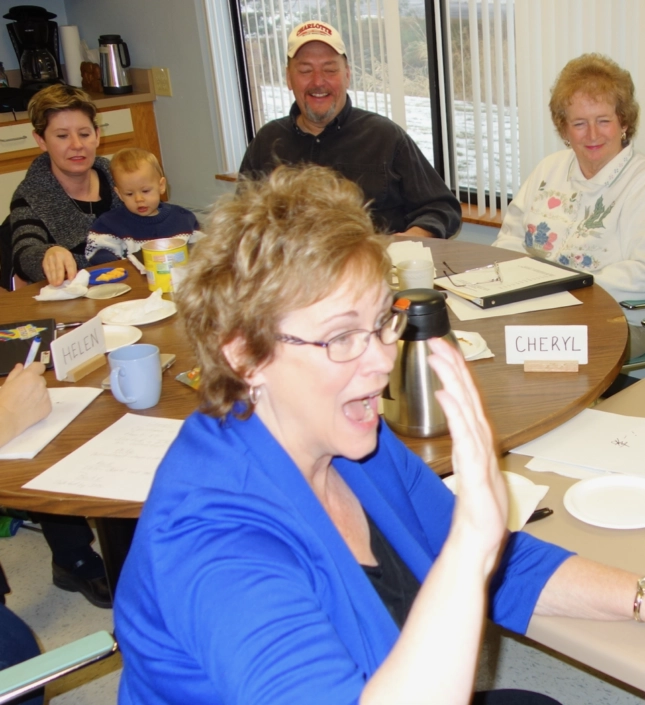 Group of people sitting around table talking and listening