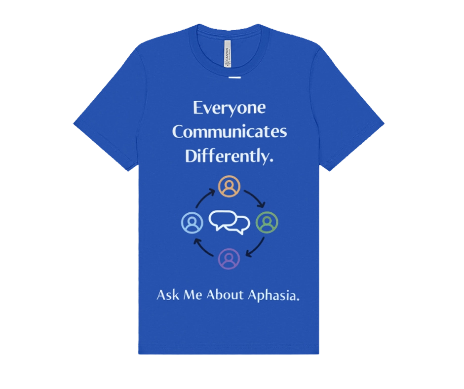 Front of a bright blue T-shirt with the message “Everyone Communicates Differently.” Below the text is a graphic of four people icons connected in a circle around speech bubbles. The shirt also says, “Ask Me About Aphasia.”